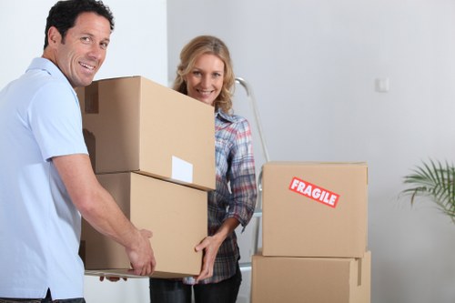 Local moving team transporting boxes and appliances in Enfield